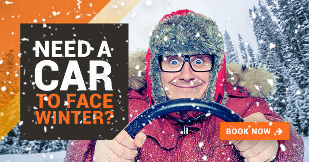 Hold the wheel in the snow in a red coat